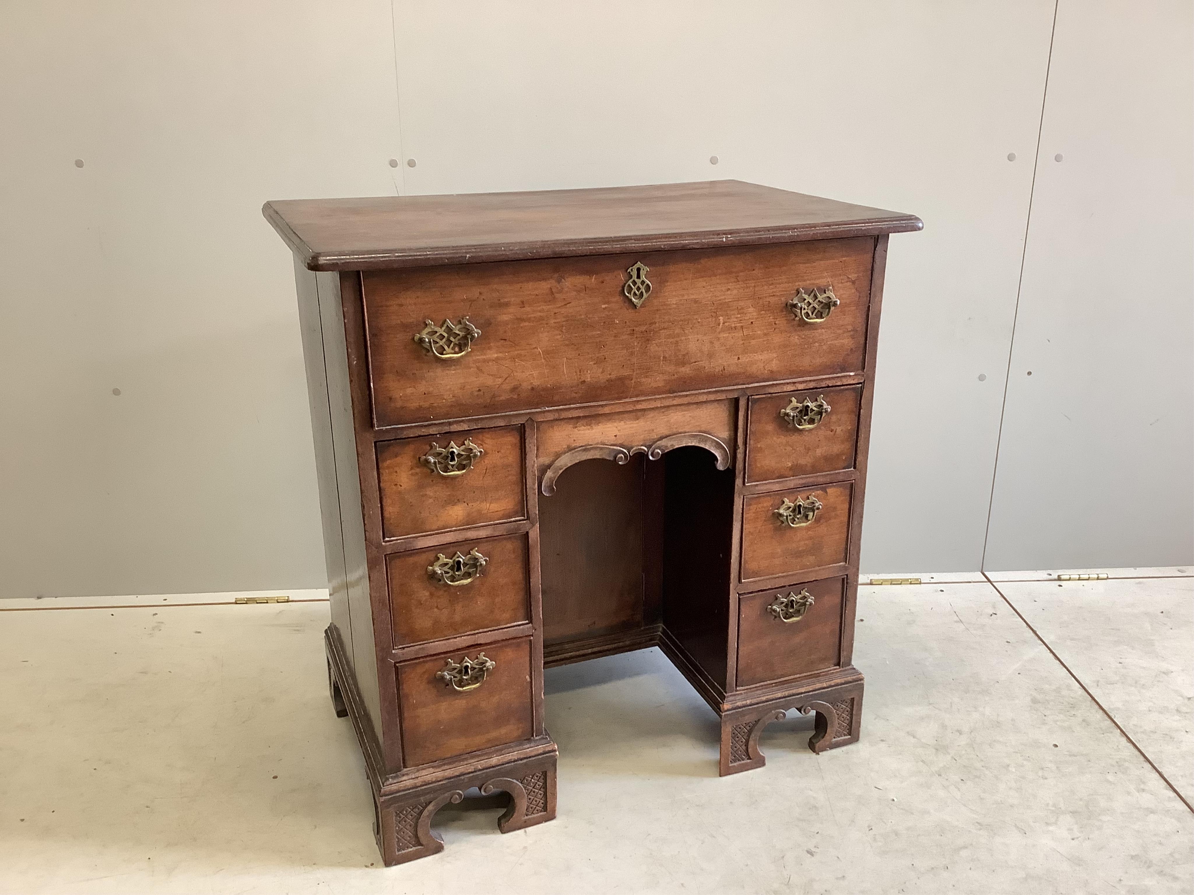 A George III mahogany kneehole desk with later secretaire drawer, width 84cm, depth 55cm, height 87cm. Condition - poor to fair